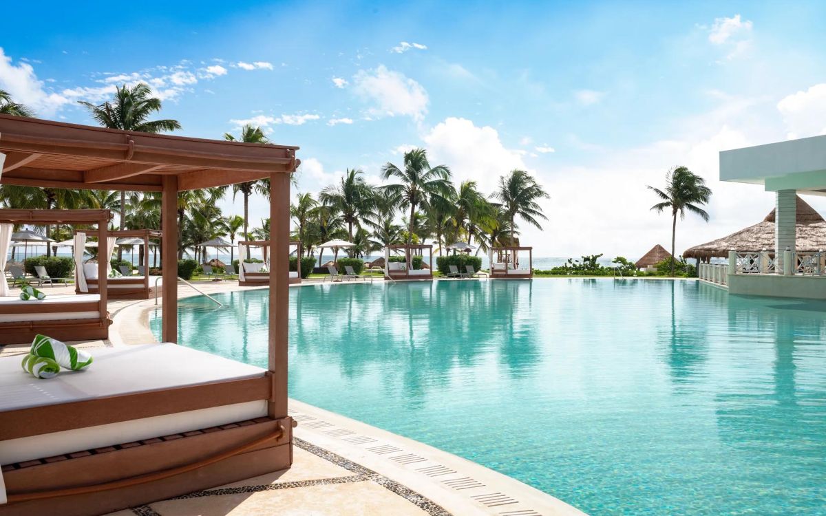 Beachfront pools and tropical grounds at Luxury Puerto Morelos Resort & Spa